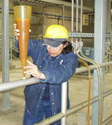 Surface water treatment plant operator checks the settling rate.